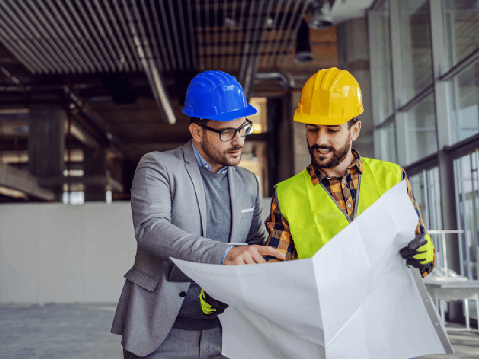 2 construction workers coordinating together on-site